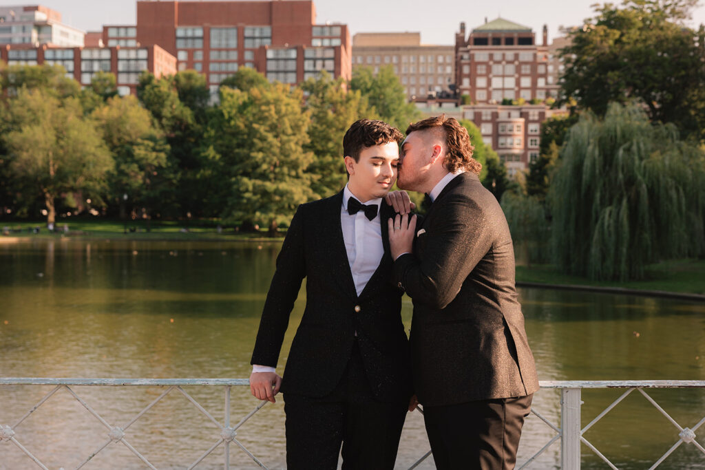 A gay couple stands on lagoon bridge for their proposal in the Boston Public Garden.