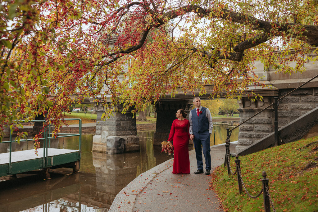 A couple stands under Lagoon Bridge near the swan boat dock in the Boston Public Garden for the proposal in Boston.